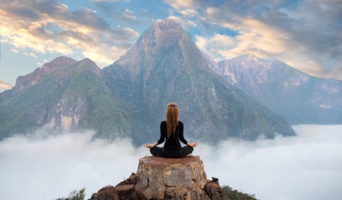 Serenity and yoga practicing,meditation at mountain range
